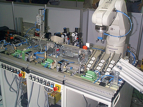 The final assembly - all competitors had built an assembly line that manufactures a number of variants of products that have 3 different coloured housings and 3 instruments - clock, hydrometer and thermometer. The slides at the front of the robot station contain the instruments, the slides on the right are for the finished product by instrument type.